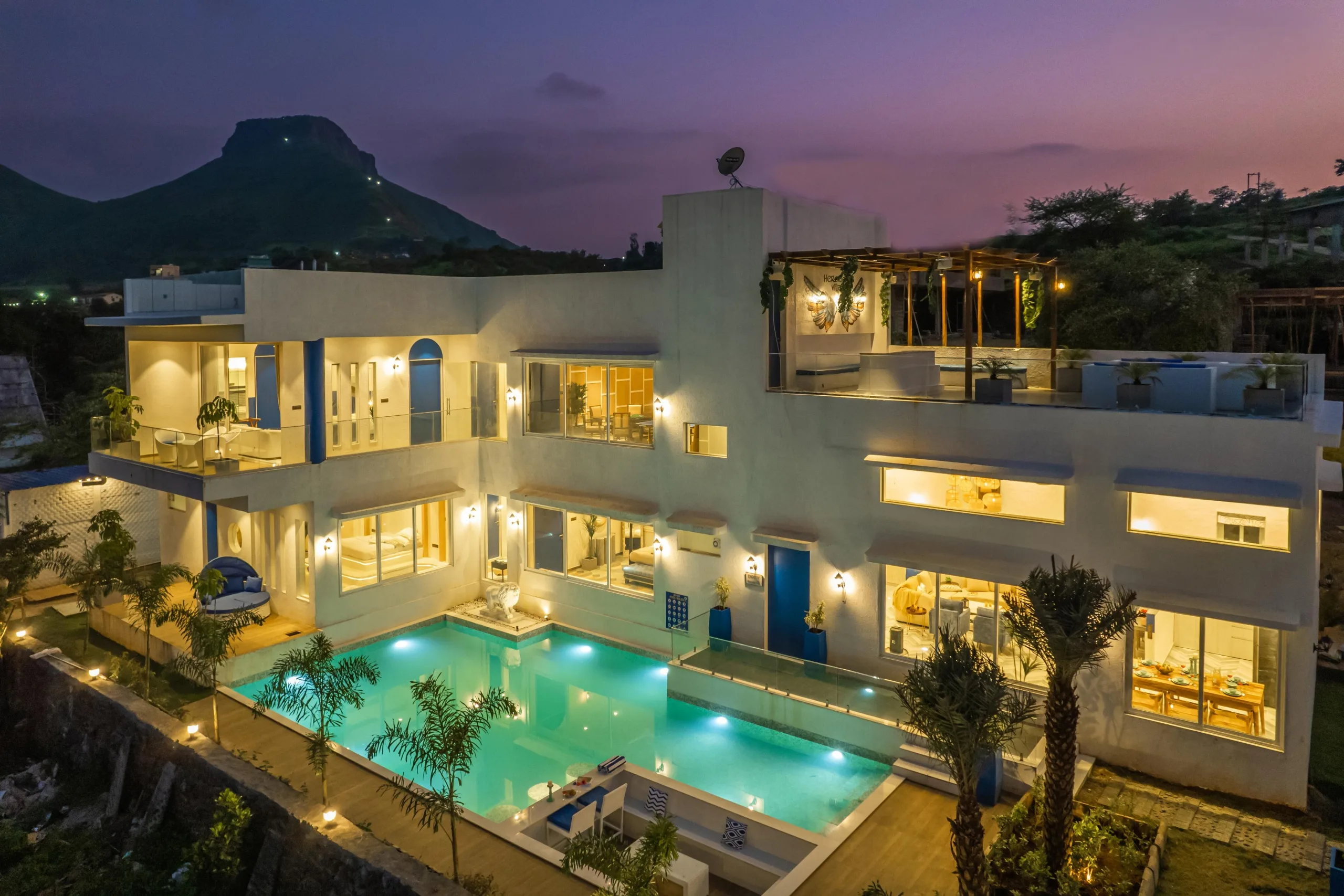 A large white villa above its pool and grounds