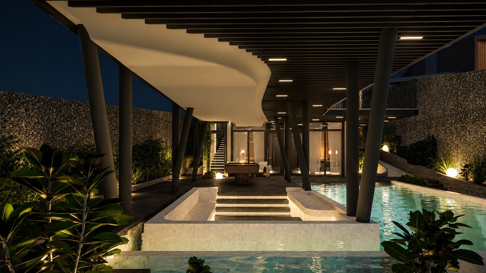 The covered lounge beside the pool after dark